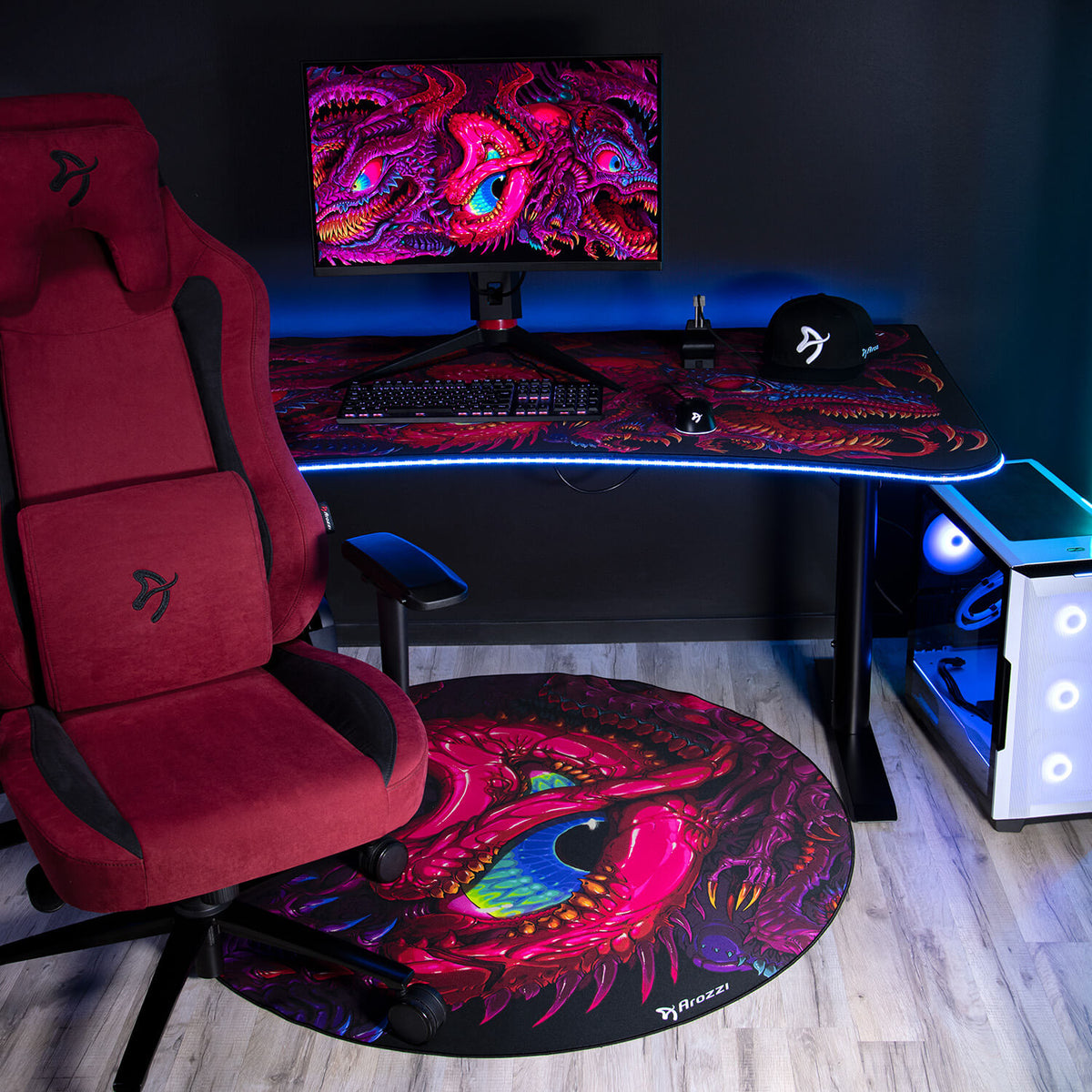Arozzi Europe Zona Round Floor Pad shown with gaming chair, dragon desk, monitor, and keyboard.
