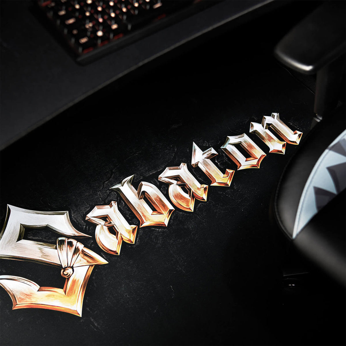 Arozzi Zona Square Floor Pad - Sabaton Edition: gold logo on black, protects your gaming space.