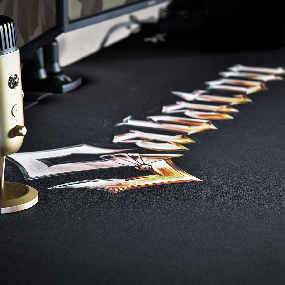Gold mic and monitor on desk with Arozzi Europe Arena Mousepad featuring MTG-style text.