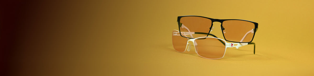 Two pairs of stylish eyeglasses with lightly tinted lenses on a yellow background.
