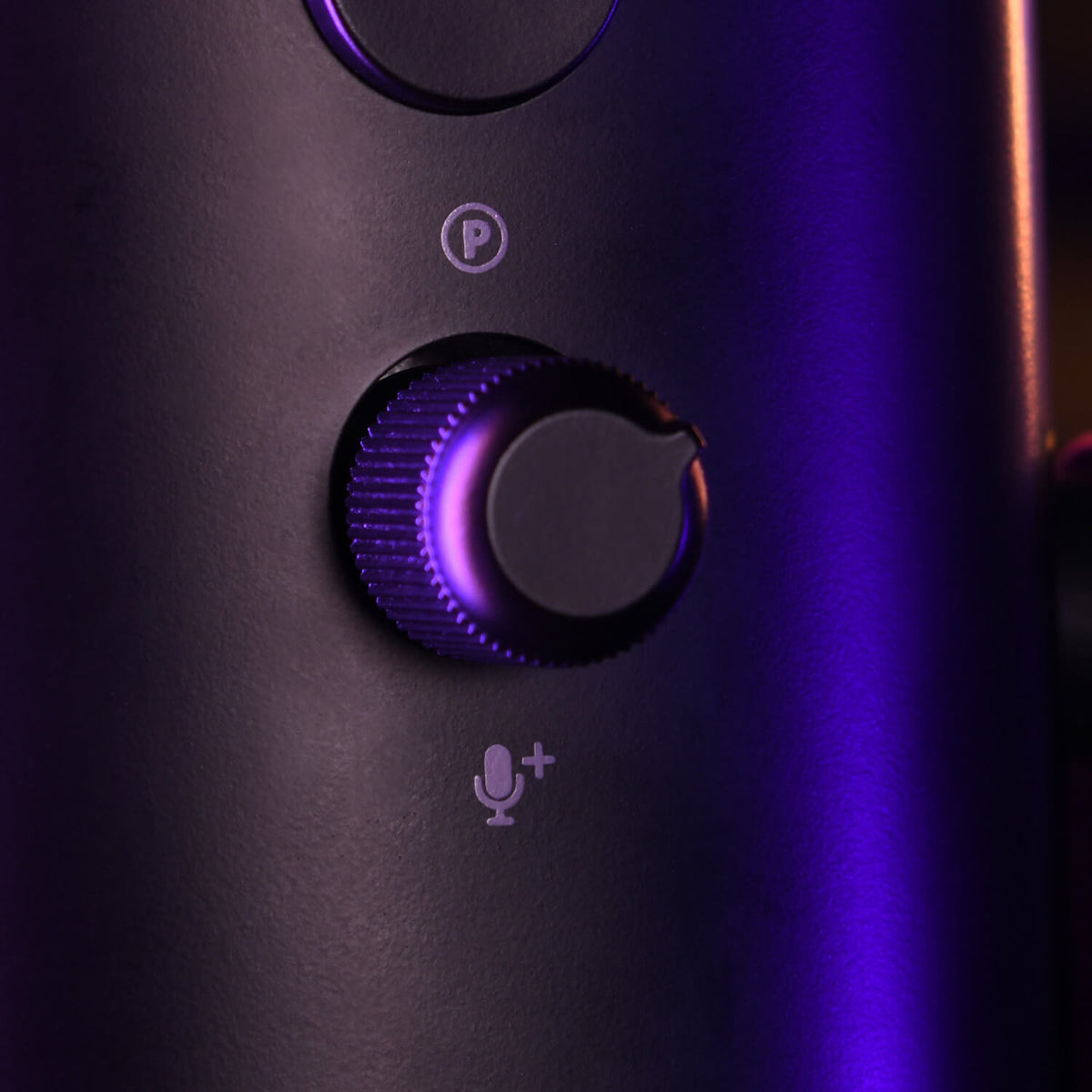 Close-up of a microphone gain knob with purple lighting.
