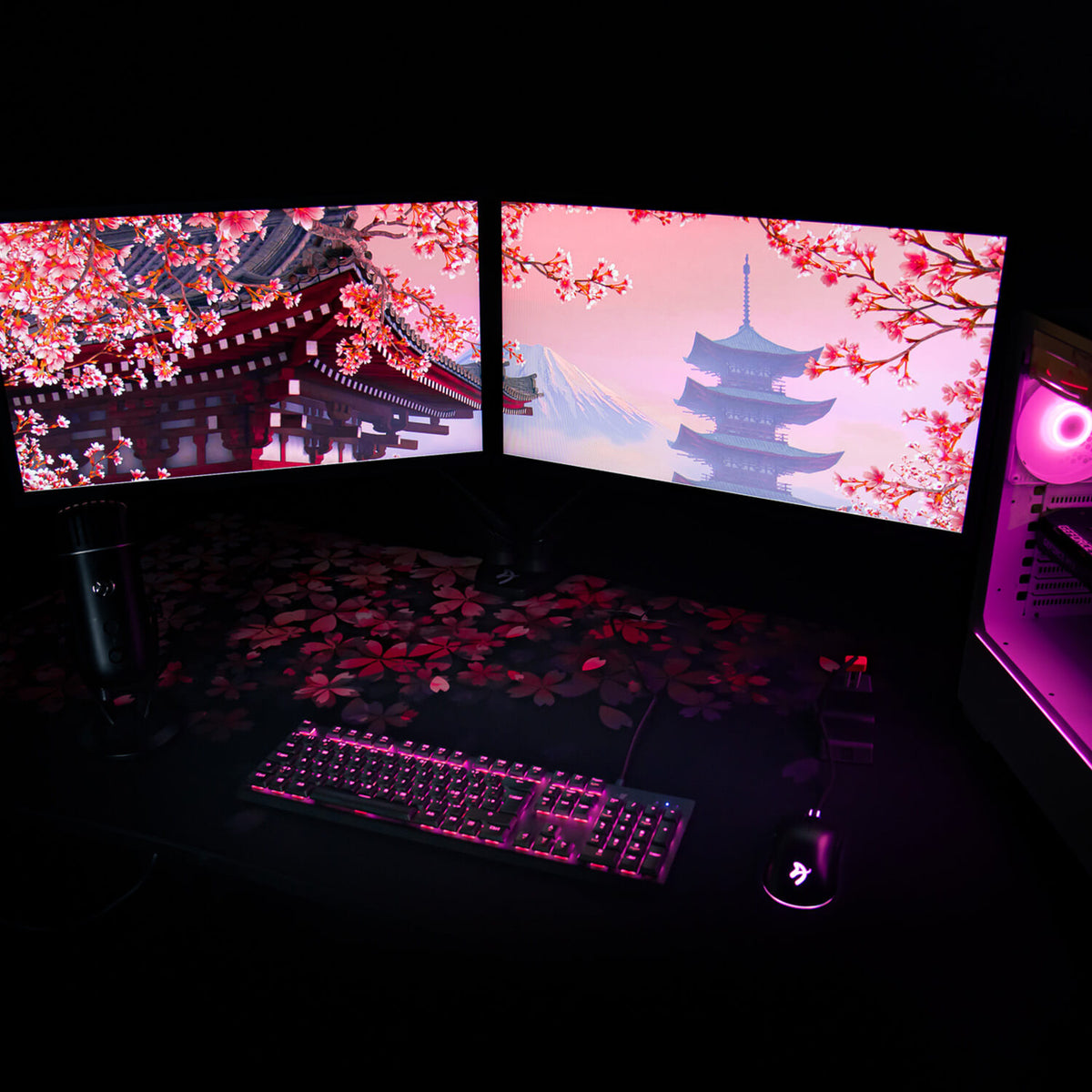 Dual monitors, cherry blossom wallpaper, pink-lit PC, Arena Mousepad by Arozzi in the dark.