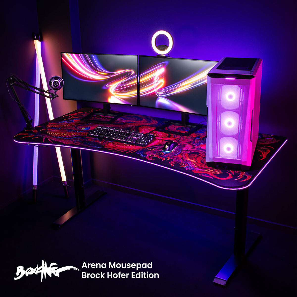 Arozzi Europe’s Arena Mousepad on a sleek gaming desk with dual monitors and neon lights.