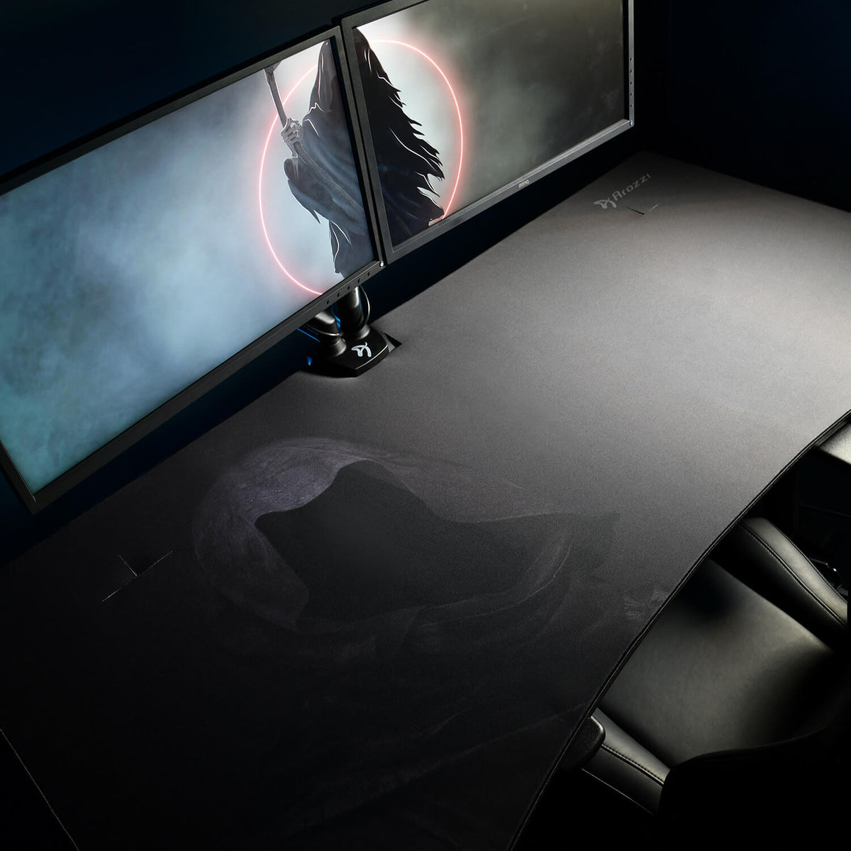 Arozzi Europe Arena Mousepad on a large black desk with dual monitors and a black chair.