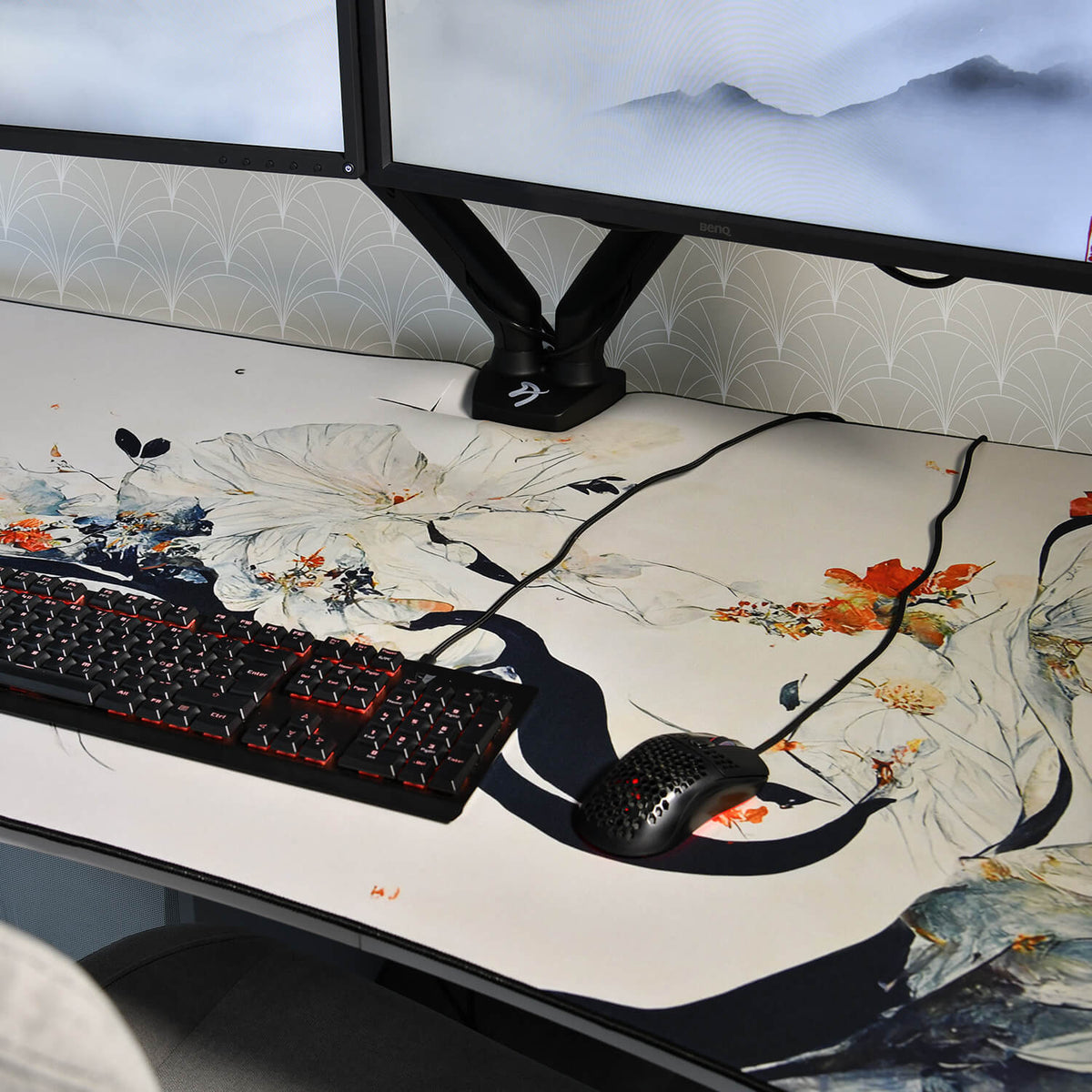 Dual monitors, Arozzi Europe Arena Mousepad, black wired keyboard, and mouse on a workstation.