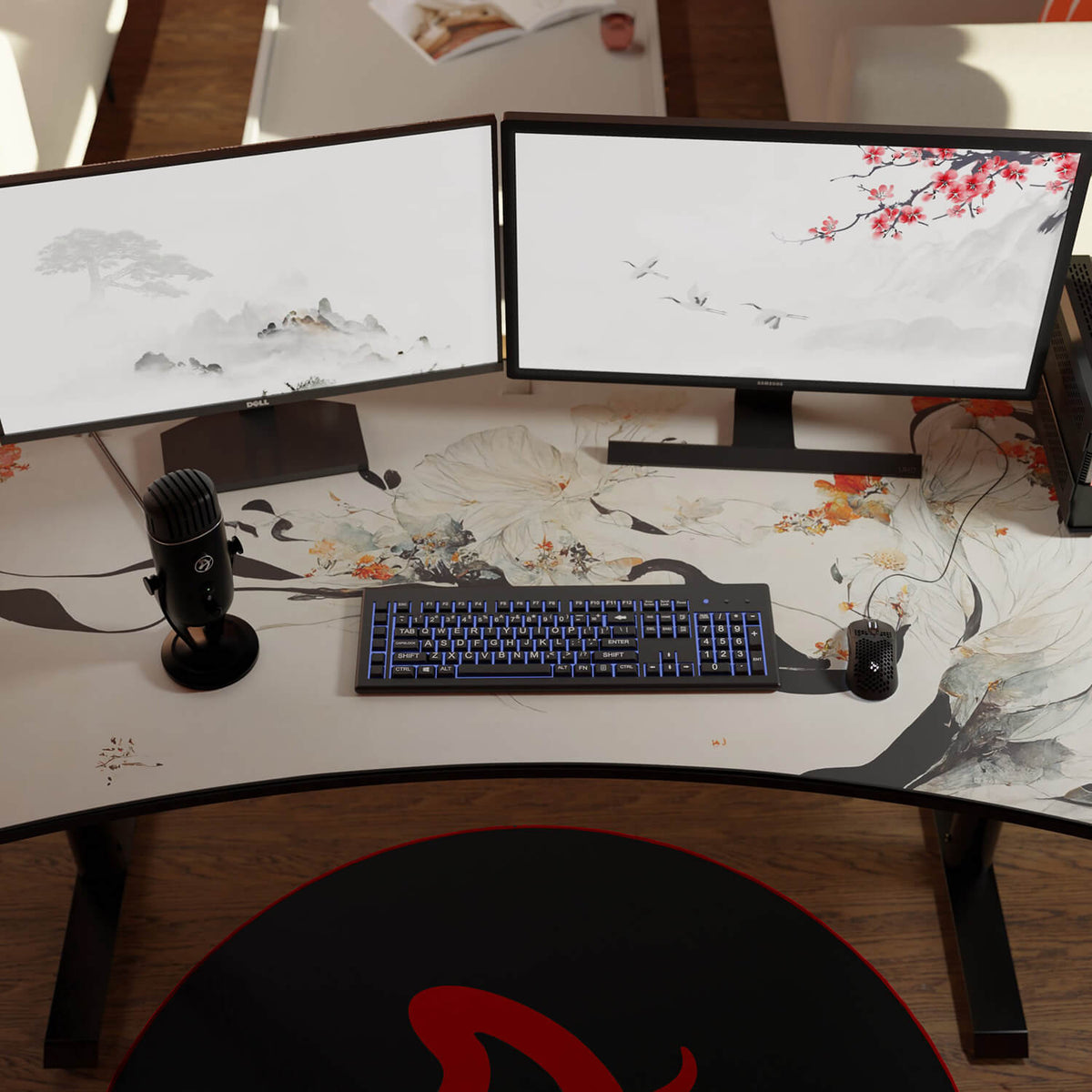 Dual monitors, keyboard, and mic on a desk with floral art and an Arozzi Arena Mousepad.