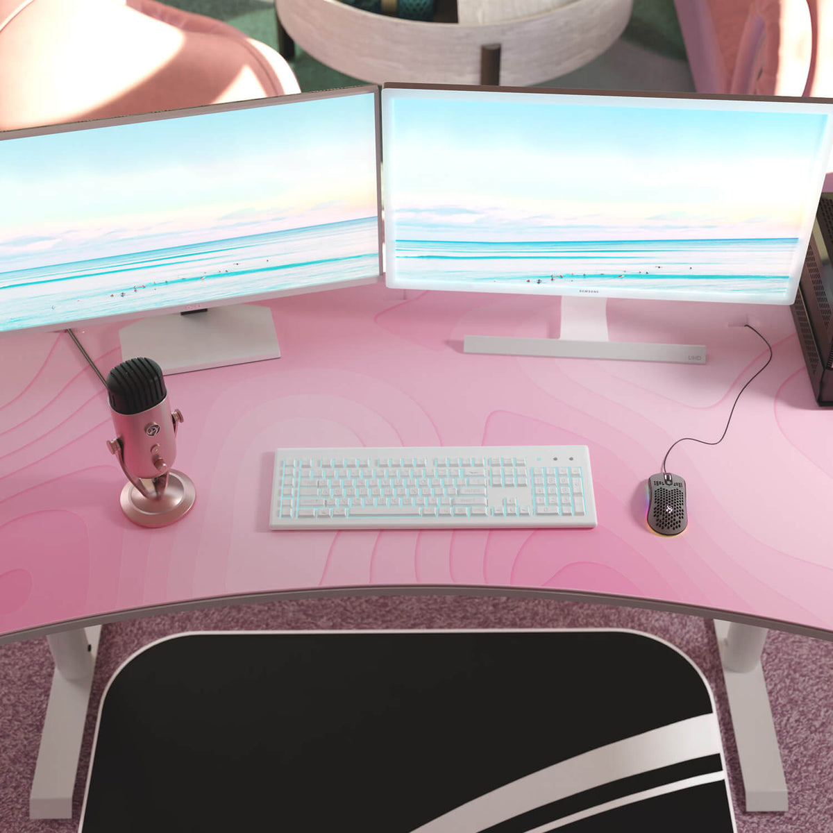 Pink desk setup: dual monitors, white keyboard, mouse, pink mic on Arozzi Europe Arena Mousepad.