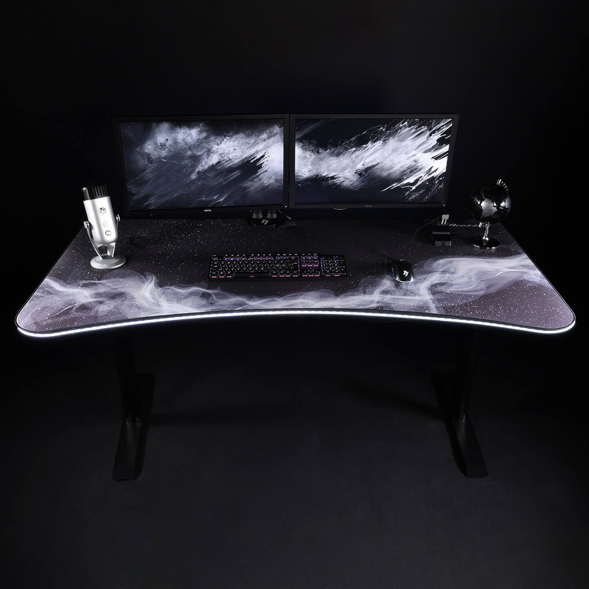 Dual monitors, keyboard, Arozzi Europe Arena Mousepad, microphone & fan on a galaxy-themed desk.
