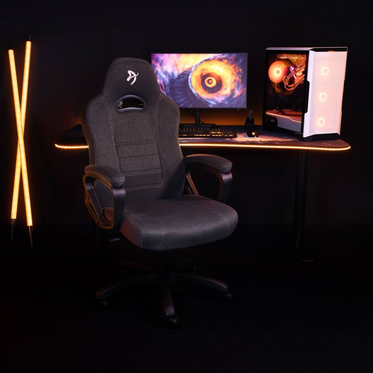 Arozzi Europe Enzo Woven Fabric chair in gray at a PC desk with monitor, keyboard, orange LEDs.