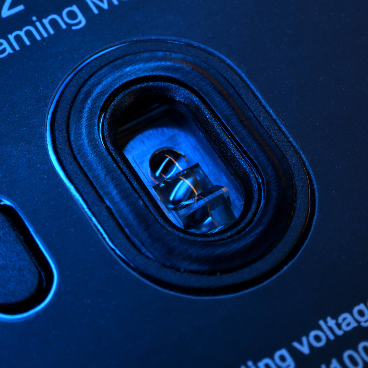 Close-up of a blue-lit electrical socket or connector on a dark device.