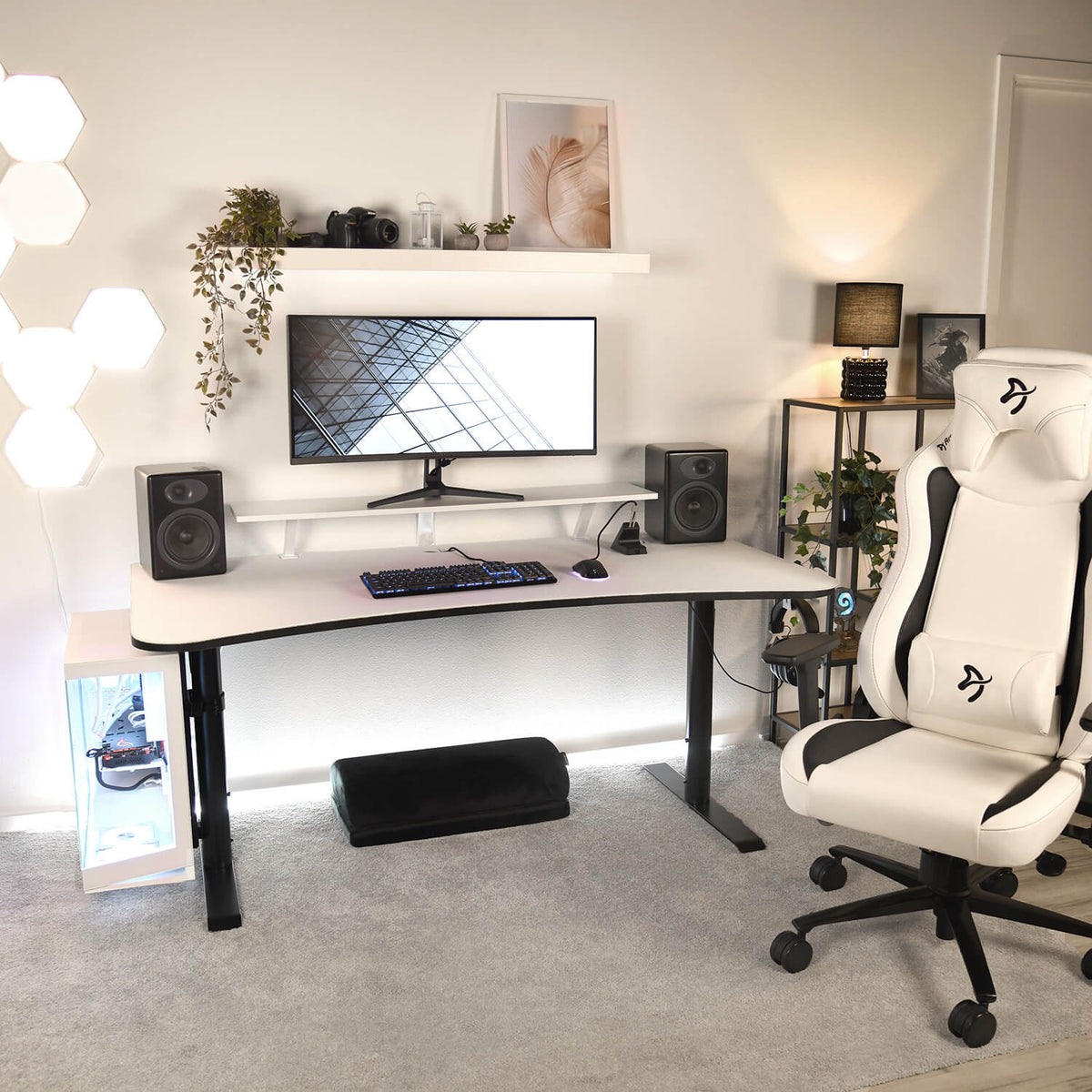 Modern desk with monitor, speakers, and Arozzi Europe Footrest for enhanced comfort.