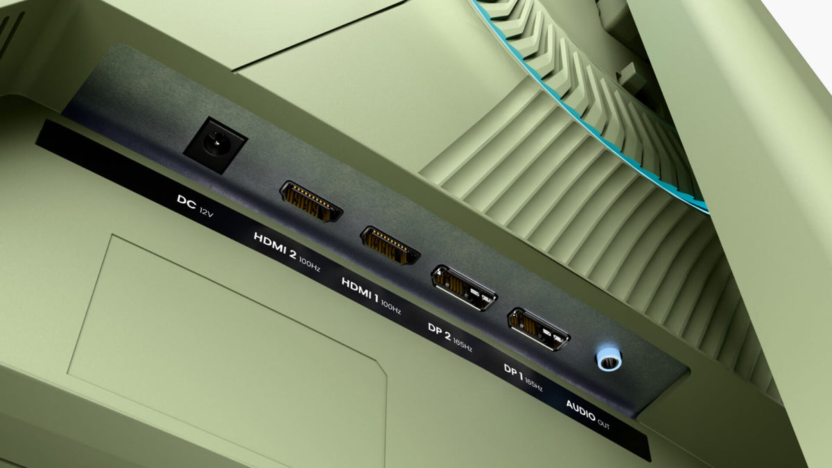 Close-up of computer ports: DC, HDMI, DisplayPort, and audio out on a green device.
