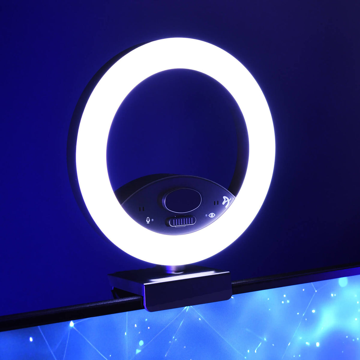 A bright ring light clipped to the top of a monitor against a blue background.