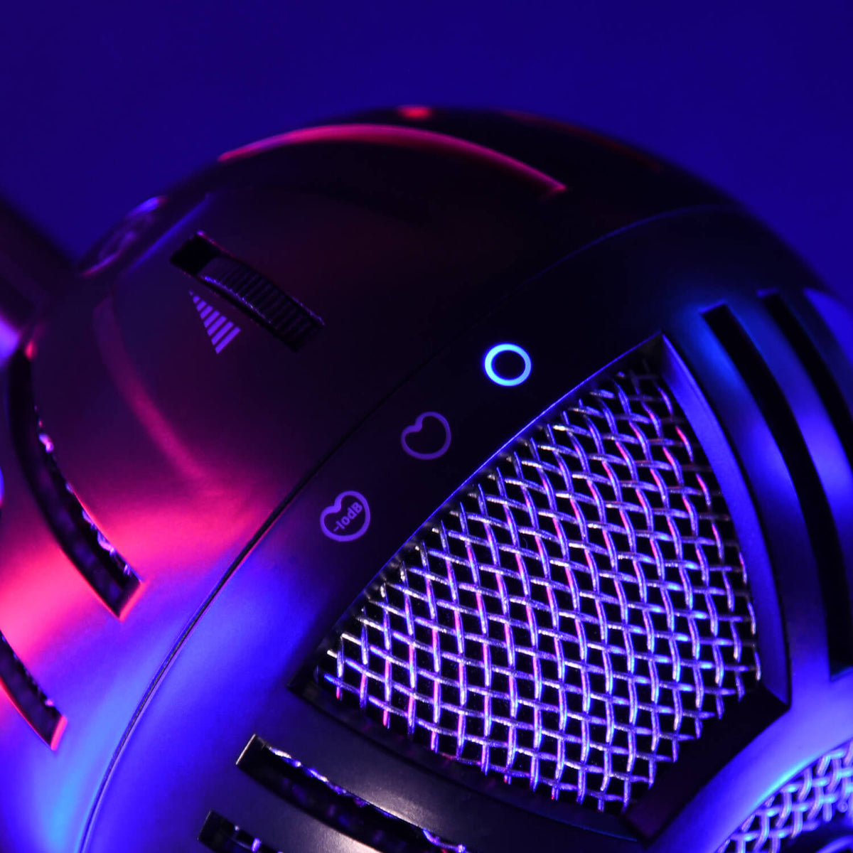 Close-up of a metallic microphone with purple and blue lighting, showing a mesh grille.