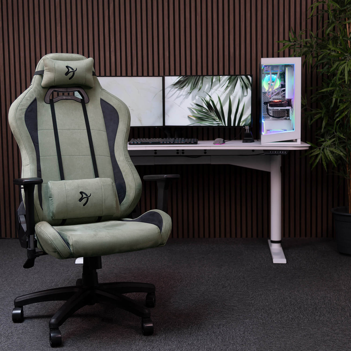 Arozzi Europe Torretta Supersoft chair at desk with dual monitors and lit-up PC case.