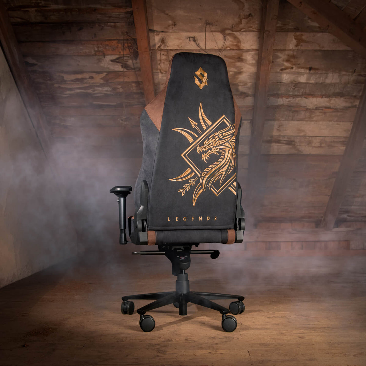 Arozzi Vernazza Supersoft Sabaton Legends chair with gold dragon, rustic attic setting and mist.