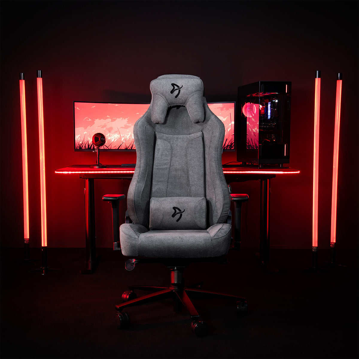 Arozzi Europe Vernazza Soft Fabric chair in front of a red-lit desk with monitor and PC.