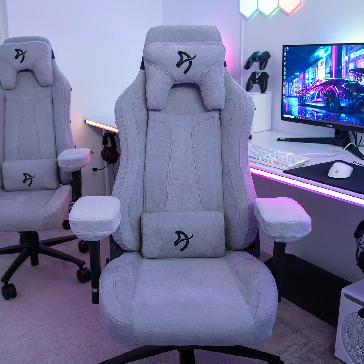 Arozzi Europe Vernazza Soft Fabric chair in gray with desk, monitor, and colorful LED lights.