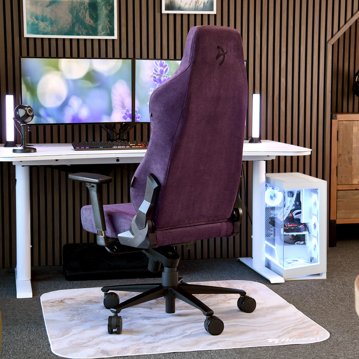 Arozzi Europe Vernazza Soft Fabric chair in purple sits by dual monitors on a sleek white desk.