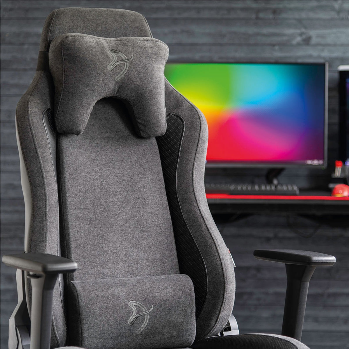 Arozzi Europe Vernazza Vento gray gaming chair in front of a desk with colorful setup.