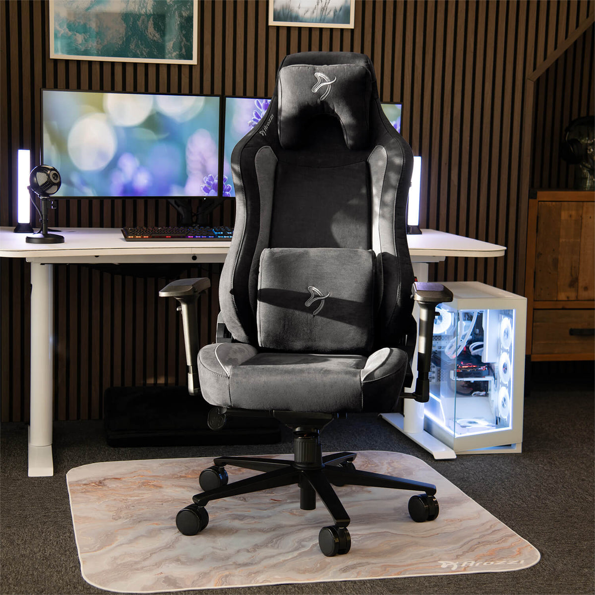 Arozzi Europe Vernazza Supersoft chair with memory foam, on a marble mat facing lit monitors.