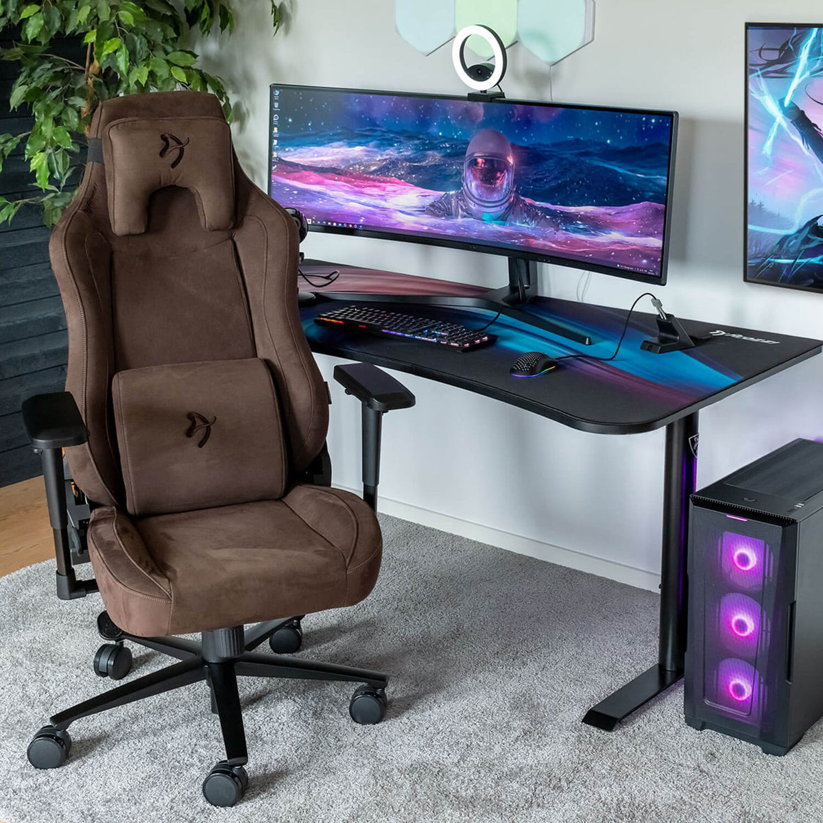 Arozzi Vernazza Supersoft chair with breathable fabric sits by a curved monitor and purple-lit PC.