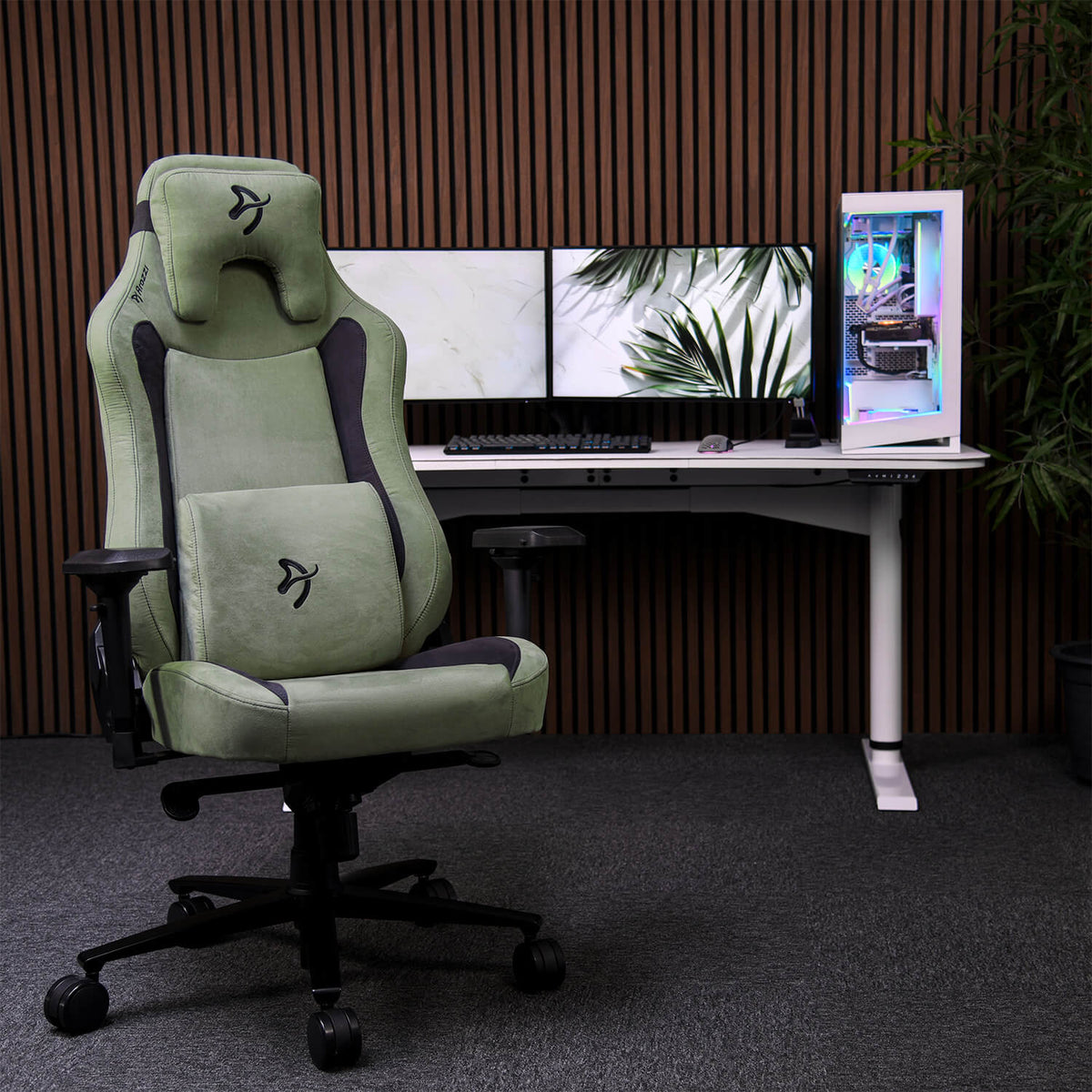 Arozzi Vernazza Supersoft chair in green, with memory foam, is placed by a dual monitor desk.