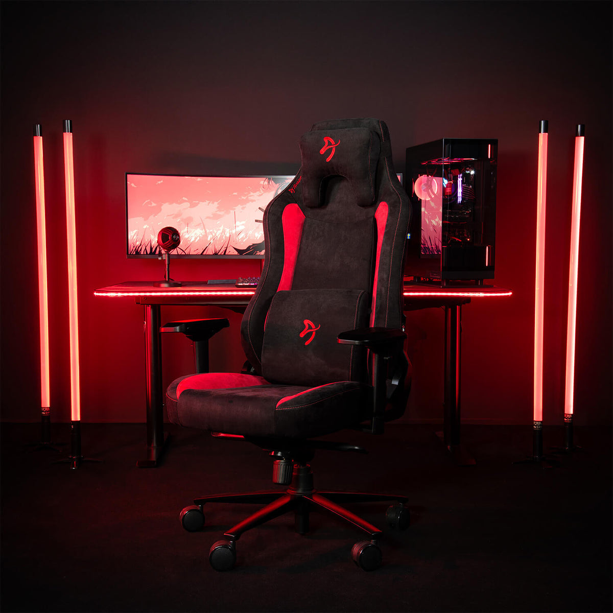 Arozzi Europe Vernazza Supersoft chair, black/red, memory foam, in front of a lit PC setup.