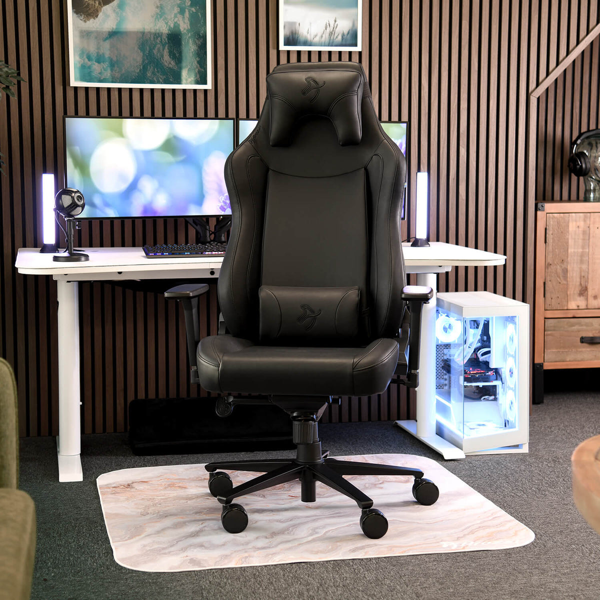 Arozzi Europe Vernazza XL SoftPU gaming chair sits by a desk with monitors and a PC tower.