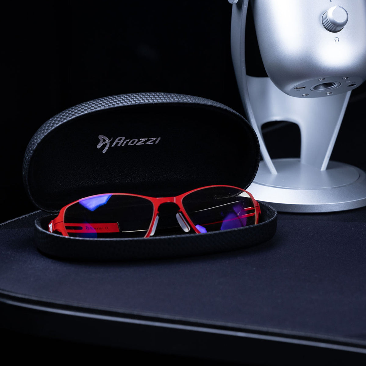 Visione VX-500 by Arozzi Europe on desk for computer use near a silver microphone.