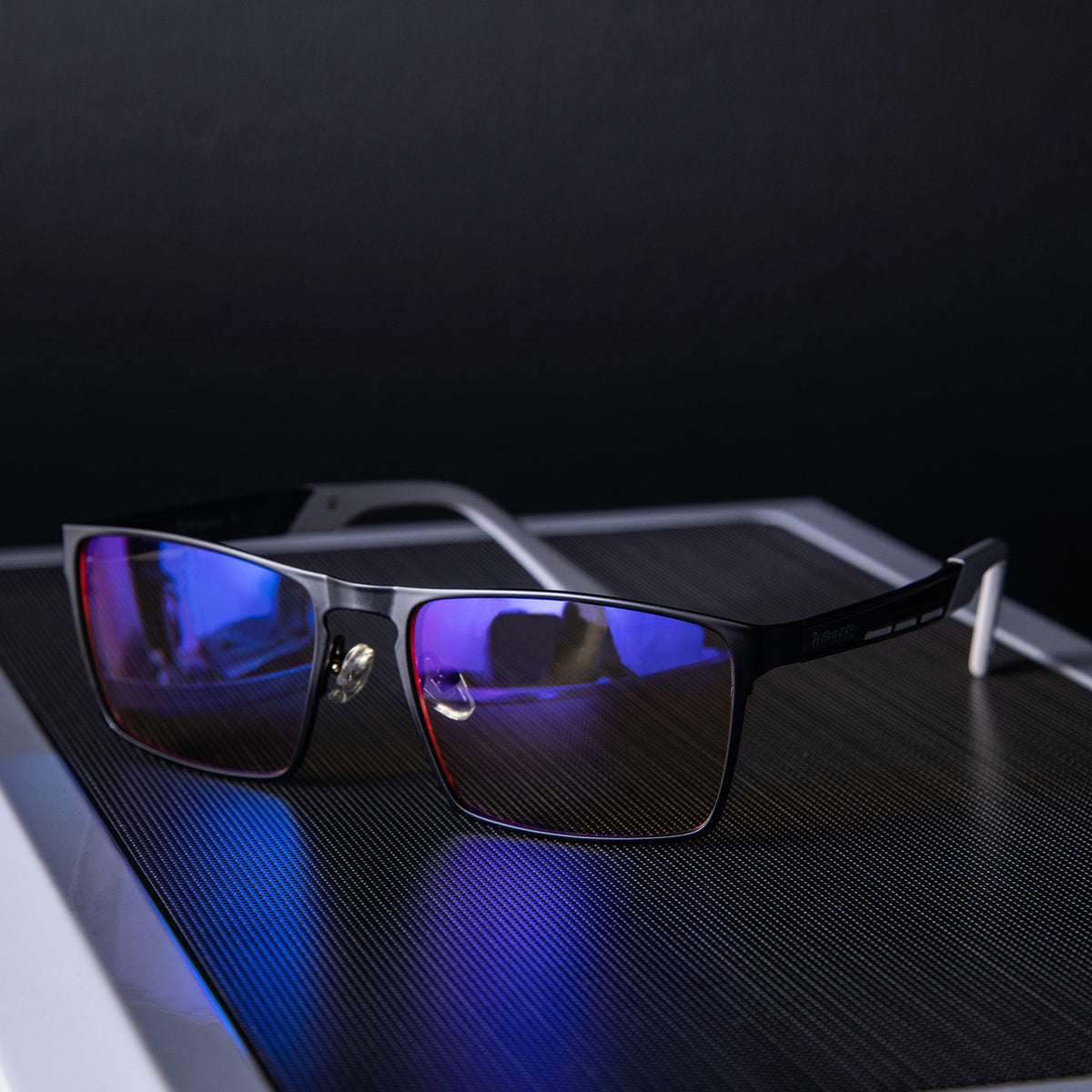 Arozzi Europe Visione VX-800 black computer glasses with blue light filter on a textured surface.