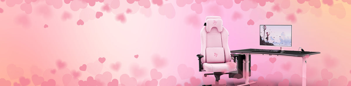 Pink gaming chair and desk with a monitor, on a pink heart-patterned background.