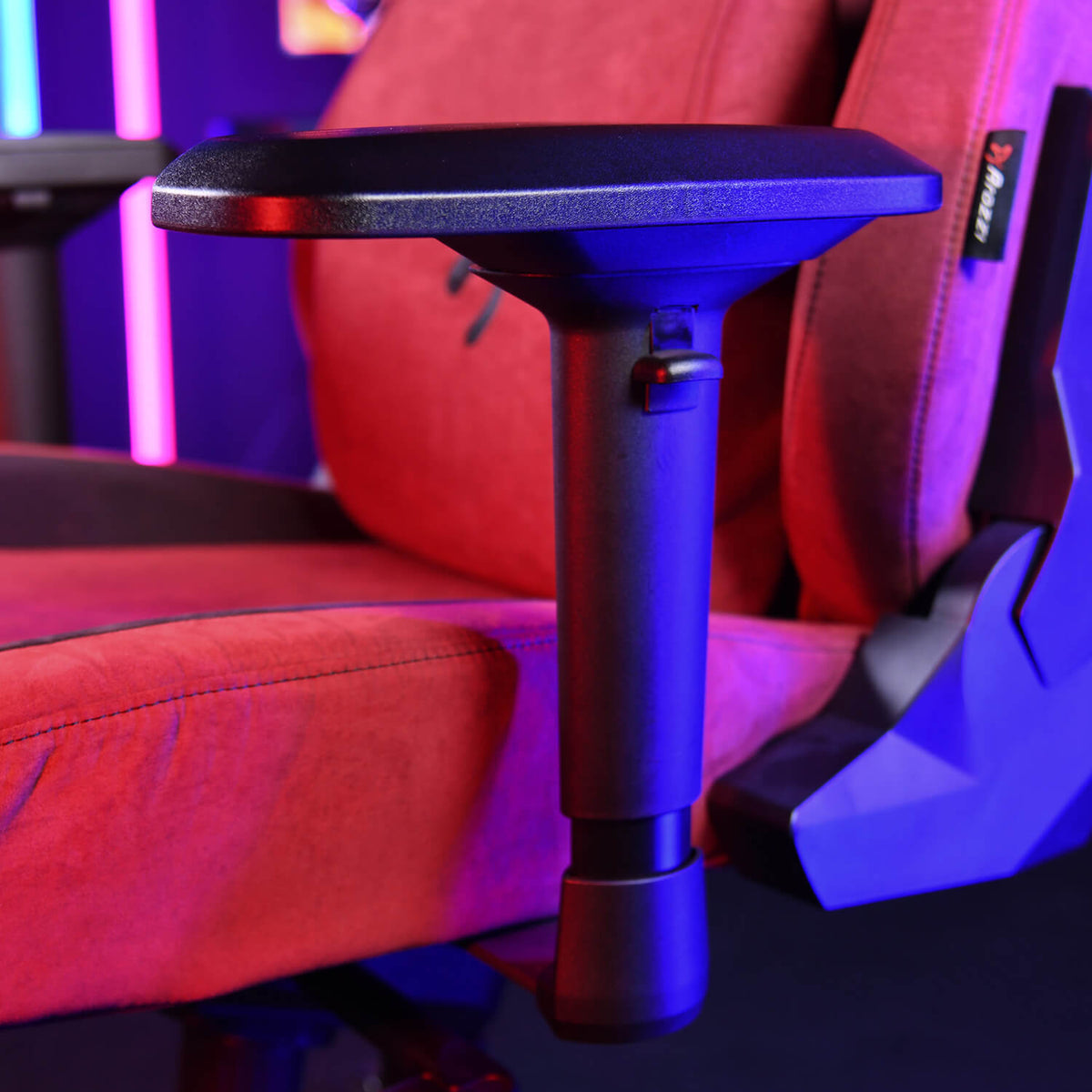 Arozzi Europe Armrests - 4D on a red gaming chair, shown under purple and blue lights.