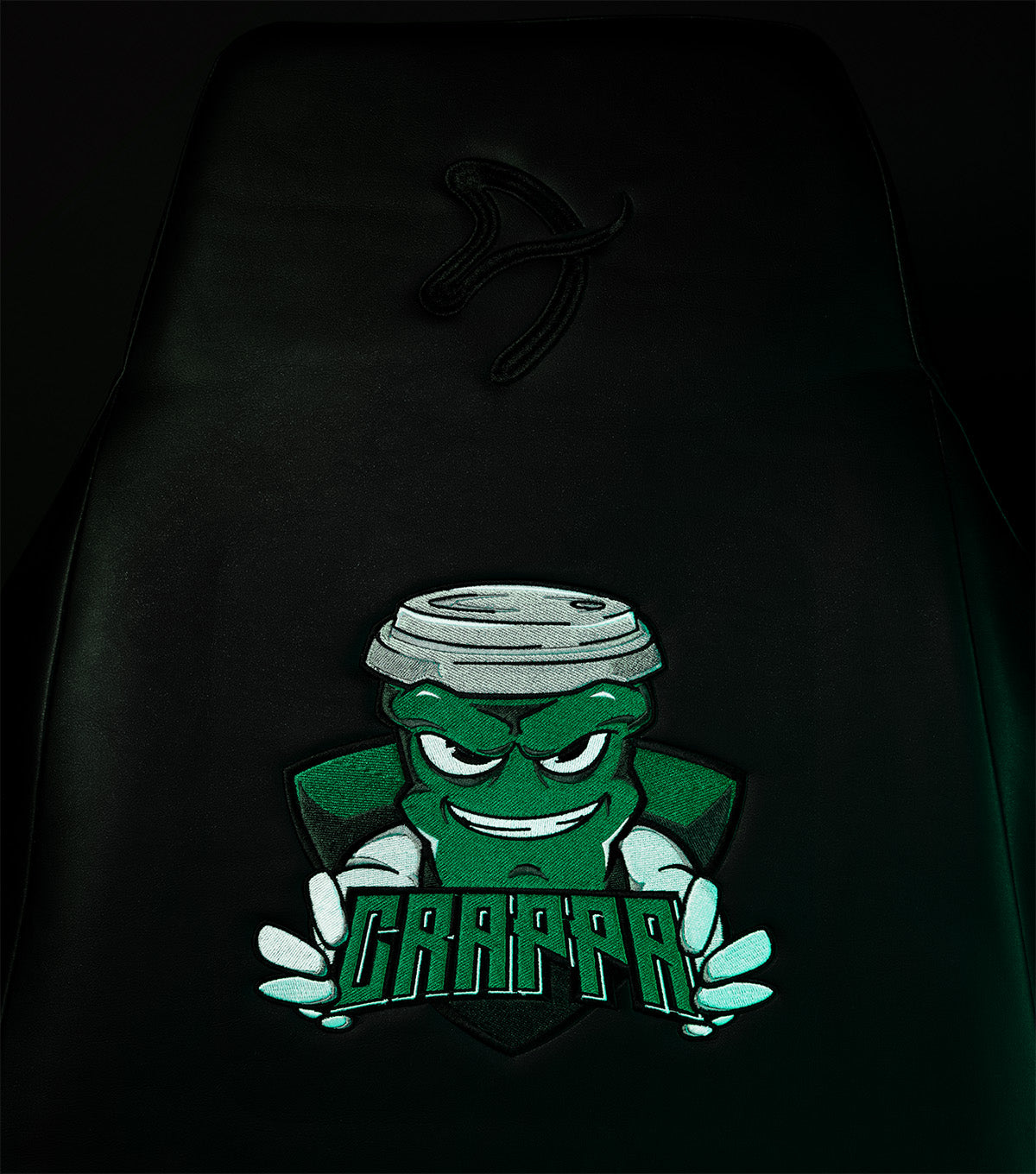 A green cartoon character with CRAPPA text on a black seatback.