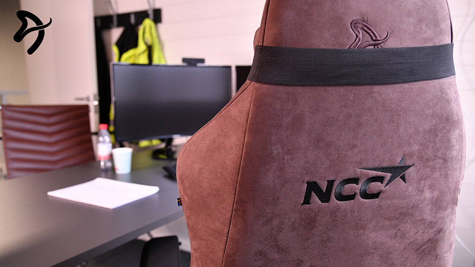 Brown office chair with NCC logo, computer monitor, and desk in background.
