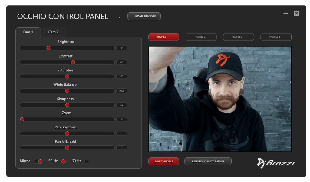 Man adjusting webcam settings on a control panel interface, wearing a black hoodie and cap.